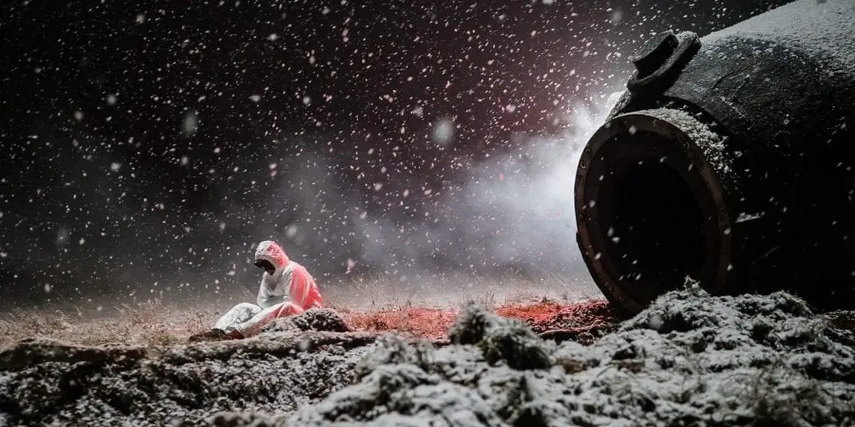 Konstantin Veshnyakov sits on the ground near Oorbiter-4 as the snow falls and blankets the area