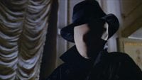 The killer from Blood and Black Lace, wearing a white face mask and a black fedora.