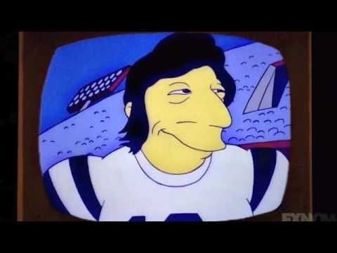 Quarterback Joe Namath, in animated form, wearing jersey, no helmet, longish hair and big sideburns clearly visible.