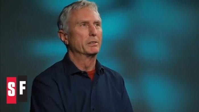 Steve Miner, mid-interview,significantly older than when he directed Ft13th Part 2. His hair is gray, he is wearing a collared shirt, and appears to be looking at something off-camera.