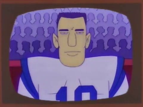 Quarterback Johnny Unitas, in animated form, from the chest up, wearing a jersey, no helmet, facing directly ahead and with a short haircut. The outlines of fans are visible in the stands behind him.