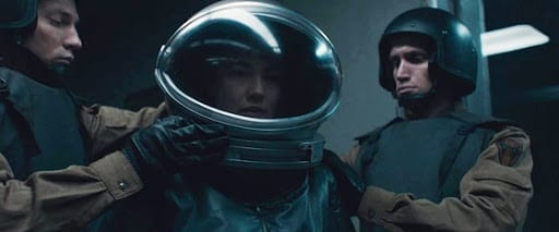Dr. Klimova is prepared in a spacesuit by two Russian soldiers before going in to face the alien