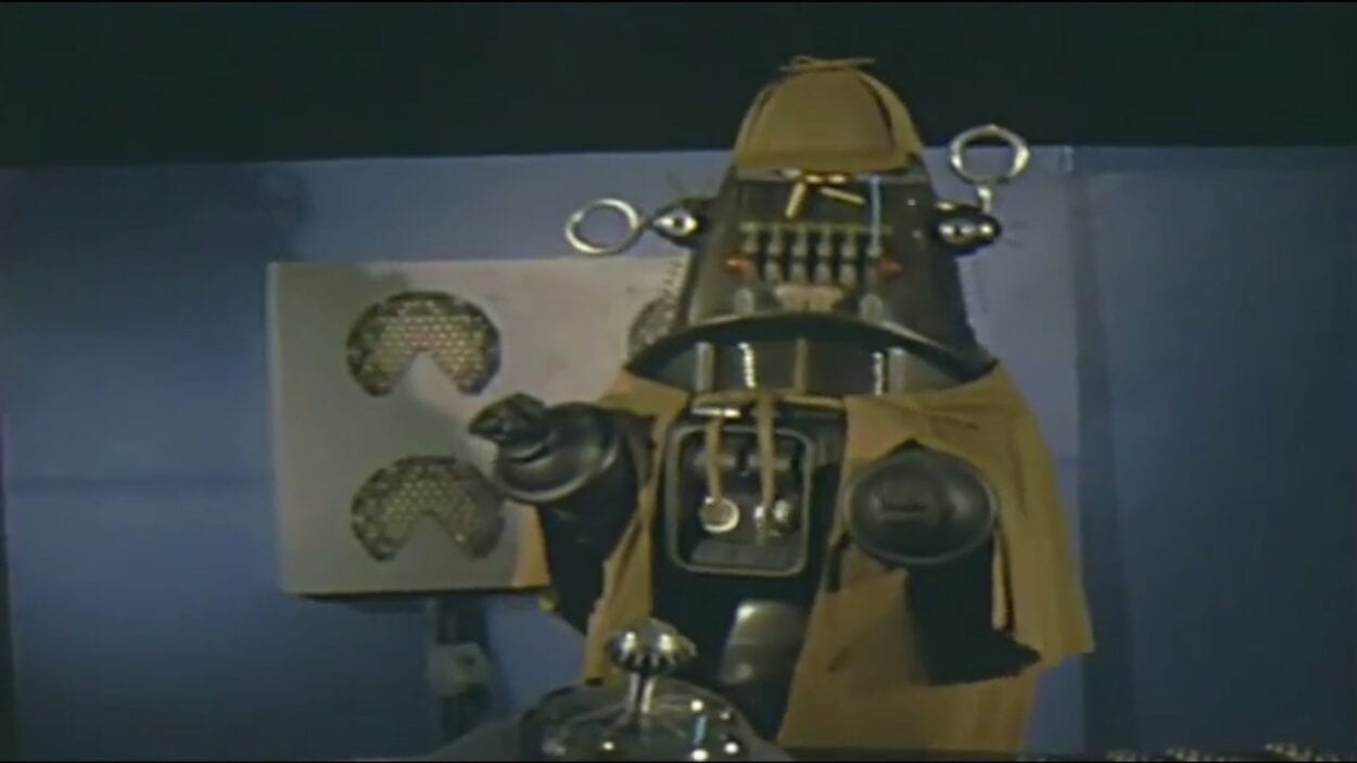 Roddy the Robot dressed in Sherlock Holmes' trademark tweed 