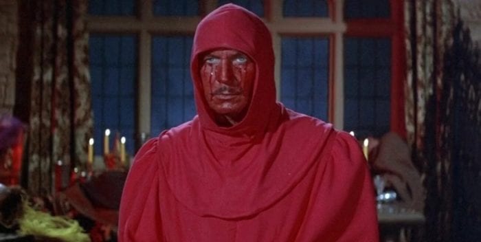 Prince Prospero is dressed in a red robe and hood with his face painted red.