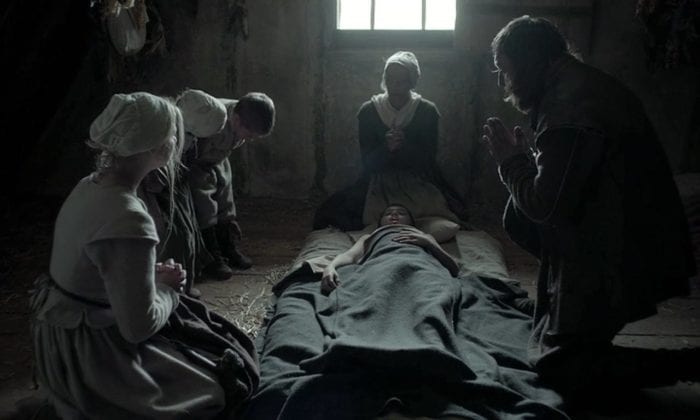 The family around Caleb as he dies