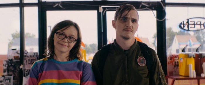 Patty (Emily Skeggs) and Simon (Kyle Gallner) stand in line at a fast food restaurant.