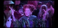 Winifred Sanderson (Bette Midler) begins to sing, "I Put a Spell on You," in the middle of a crowd, with her sisters Mary (Kathy Najimy) and Sarah (Sarah Jessica Parker) behind her, in the film "Hocus Pocus" (1993).