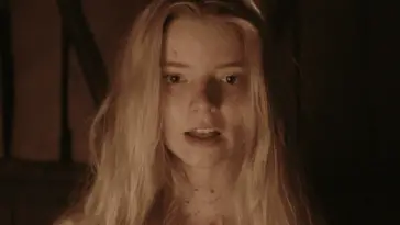 Close up of a young woman with long blonde hair, and blood on her face and neck.