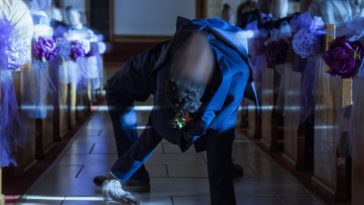 Person with a blurry face spider walking down the aisle of a church