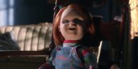 Chucky sits in doll state in a chair.
