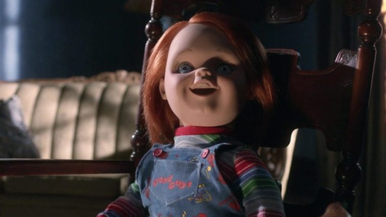 Chucky sits in doll state in a chair.