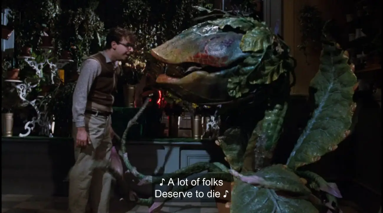 Carnivorous plant Audrey II (Levi Stubbs) sings to Seymour Krelborn (Rick Moranis), "A lot of folks deserve to die," in the film, "Little Shop of Horrors" (1986).
