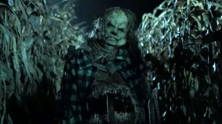 A zombified scarecrow in a corn field.