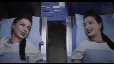 Soska sisters lie on hospital beds and smile at one another in American Mary.