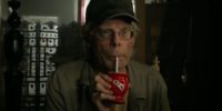 A man sips a drink through a straw.
