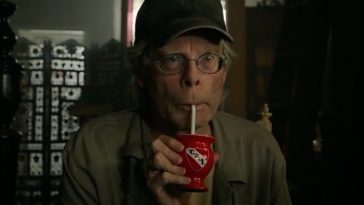 A man sips a drink through a straw.