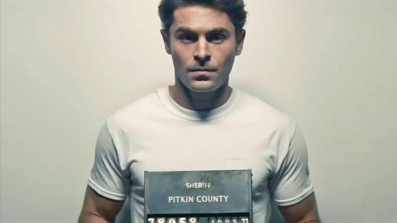 A young man scowls as he poses for a police mug shot.