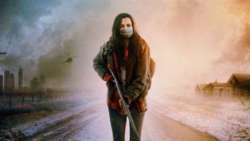 Ava Boone wears a mask and carries a gun while walking down a desolate road