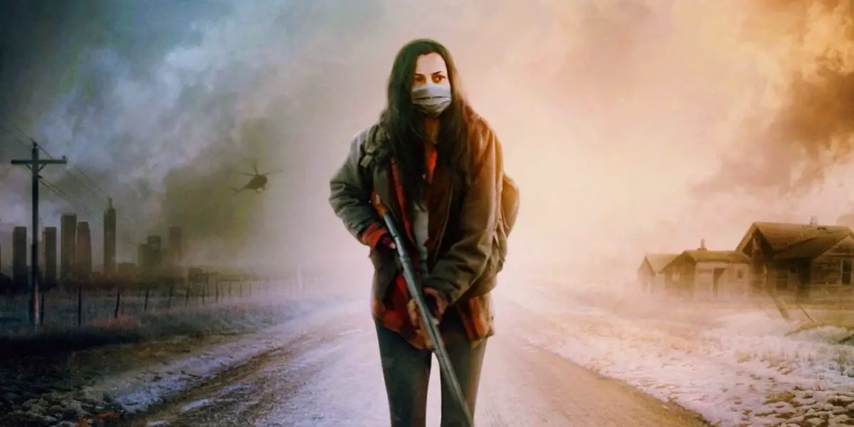 Ava Boone wears a mask and carries a gun while walking down a desolate road