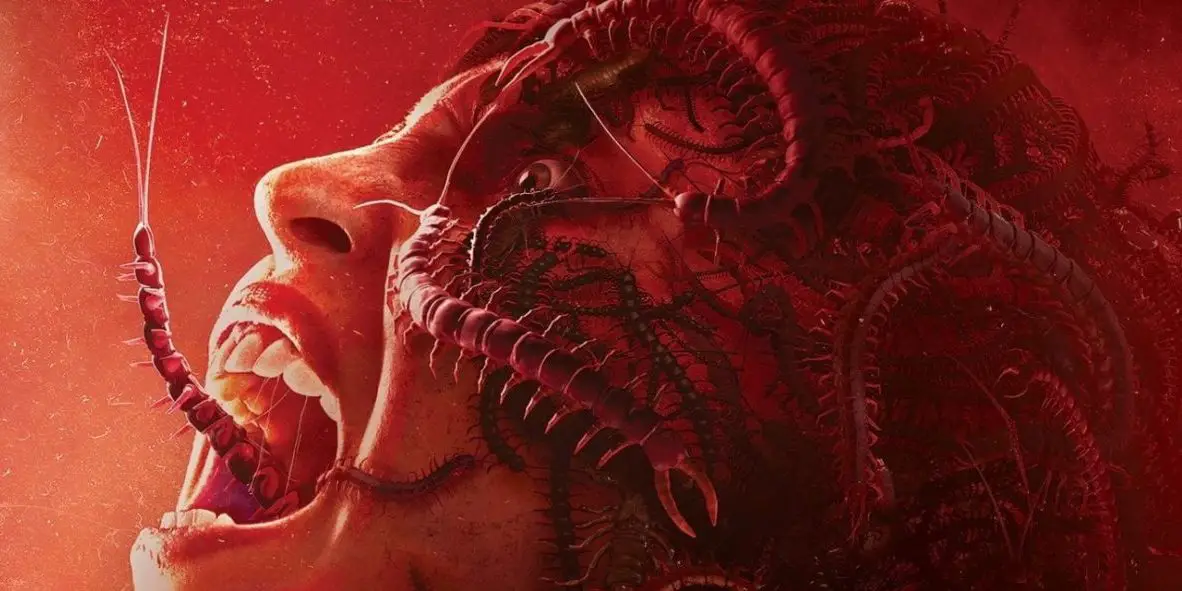 Close up of a woman screaming with centipedes crawling all over her head and out of her mouth.