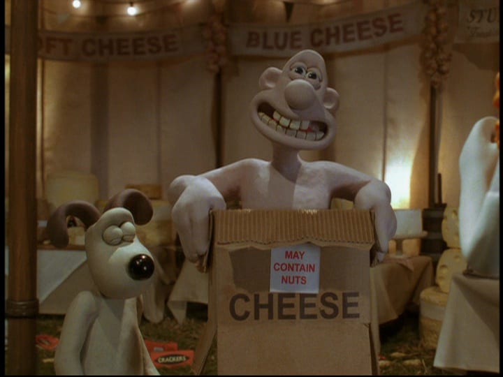 Wallace (Peter Sallis), holds up a cardboard box around himself to protect his unclothed dignity that says, "May Contain Nuts," in the film, "Wallace and Gromit: The Curse of the Were-Rabbit" (2005).
