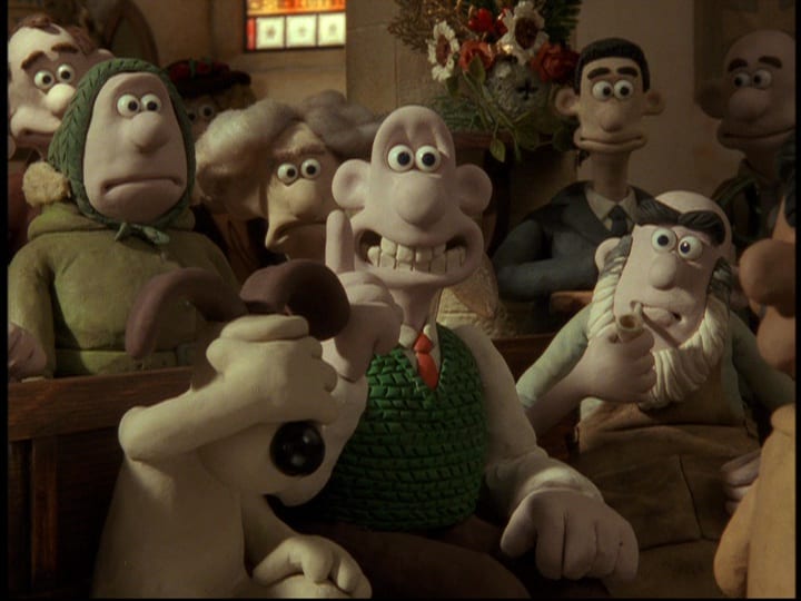 Wallace (Peter Sallis) holds up a finger, smiling with an idea, while Gromit, his dog, smacks his hand over his eyes in embarrassment, in the film, "Wallace & Gromit: The Curse of the Were-Rabbit" (2005).