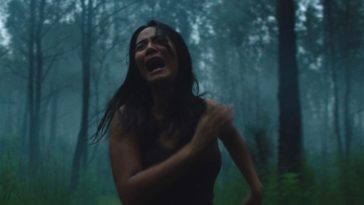 A woman runs screaming through the woods
