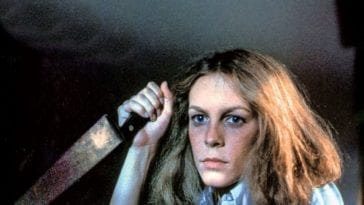 Laurie holds a knife, waiting for Michael to attack.