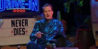 Joe Bob Briggs sitting on the set of The Last Drive-In