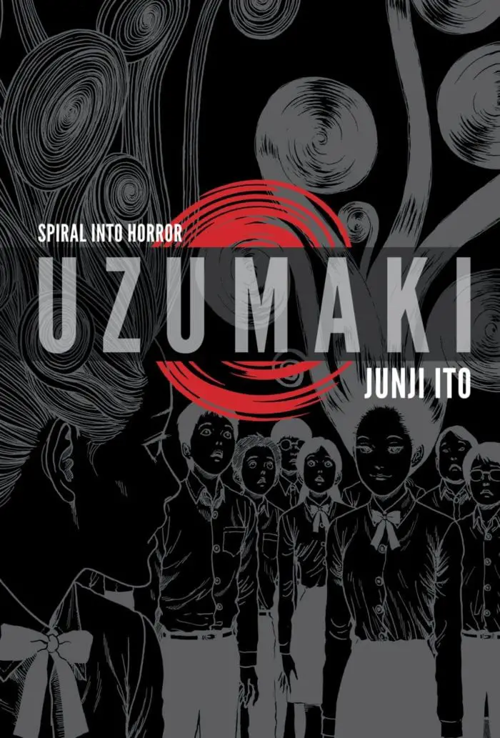 the cover for UZUMAKI by Junji Ito. many people stand smiling in photo negative colours, black on white