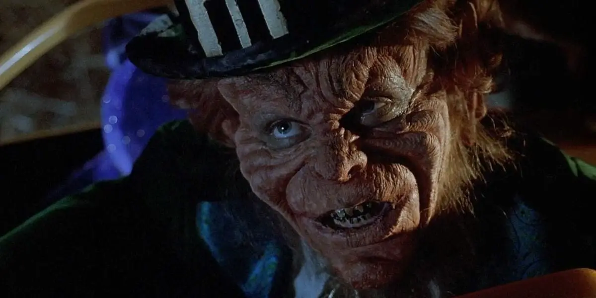 A Leprechaun stares intently with his sharp, dirty yellow teeth.