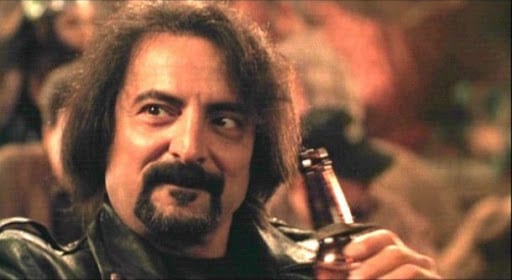 Tom Savini as The Sex Machine drinks a beer in the bar in From Dusk Til Dawn.