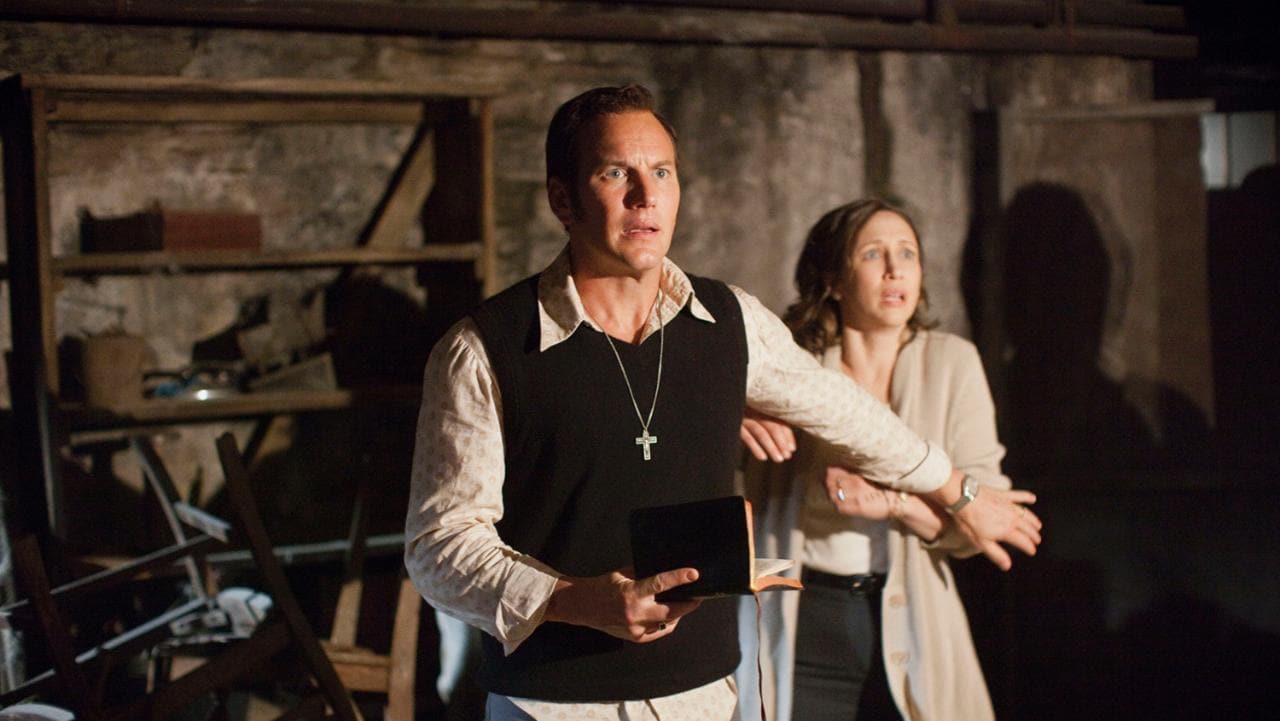 Actors depicting Ed and Lorraine Warren look aghast in the cellar in The Conjuring.