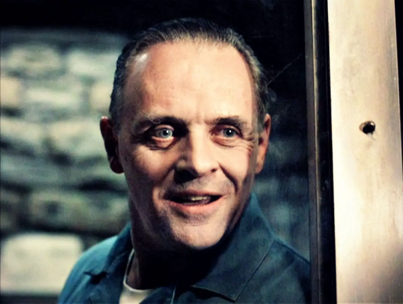 Close-up of Hannibal Lector looking through the glass of his cell.