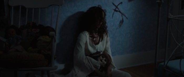 In this photo Janice aka Anabelle is seen holding the doll after she was killed. The letter A is smeared in blood on the back wall.