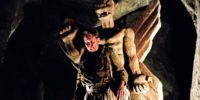 A man stands in front of an iconic demonic statue in The Exorcist prequel