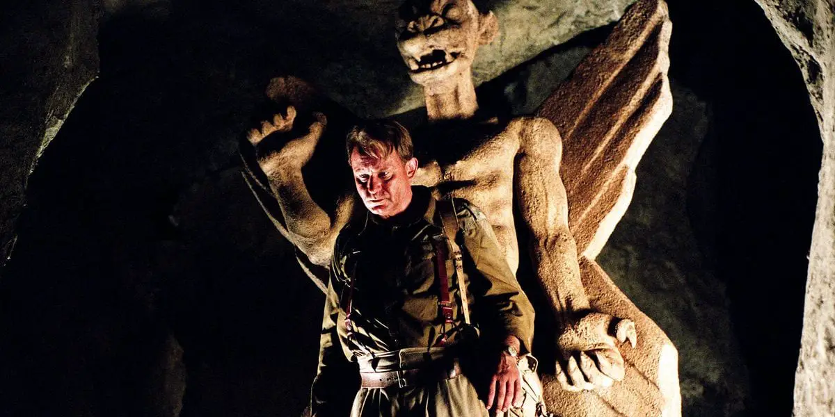 A man stands in front of an iconic demonic statue in The Exorcist prequel