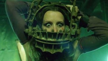 Close up of wide-eyed woman struggling with torturous device clamped around her head in Saw.