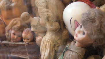 a pile of assorted porcelain dolls
