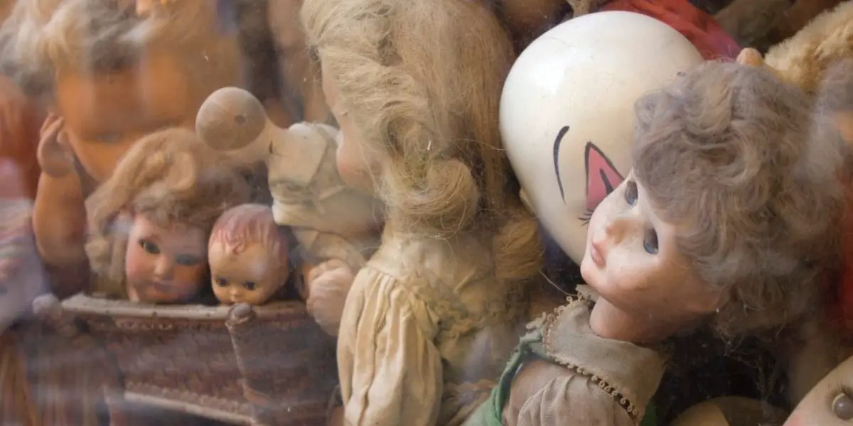 a pile of assorted porcelain dolls