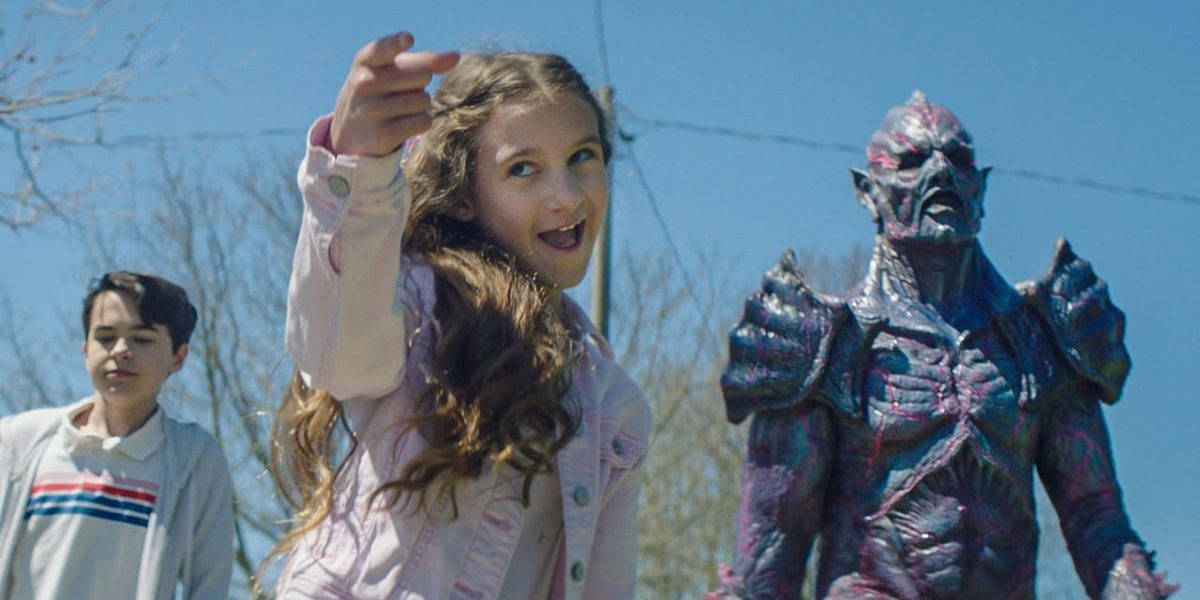 Mimi points at someone while Luke and Psycho Goreman look on