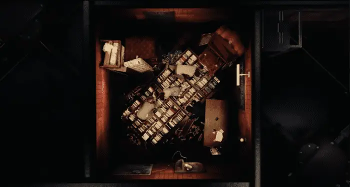 A bird's eye view of Fermat's room, bookcase laying diagonally as the participants crawl over it
