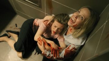 Screaming for help, Marcy holds an injured woman in the corner of a bathroom.