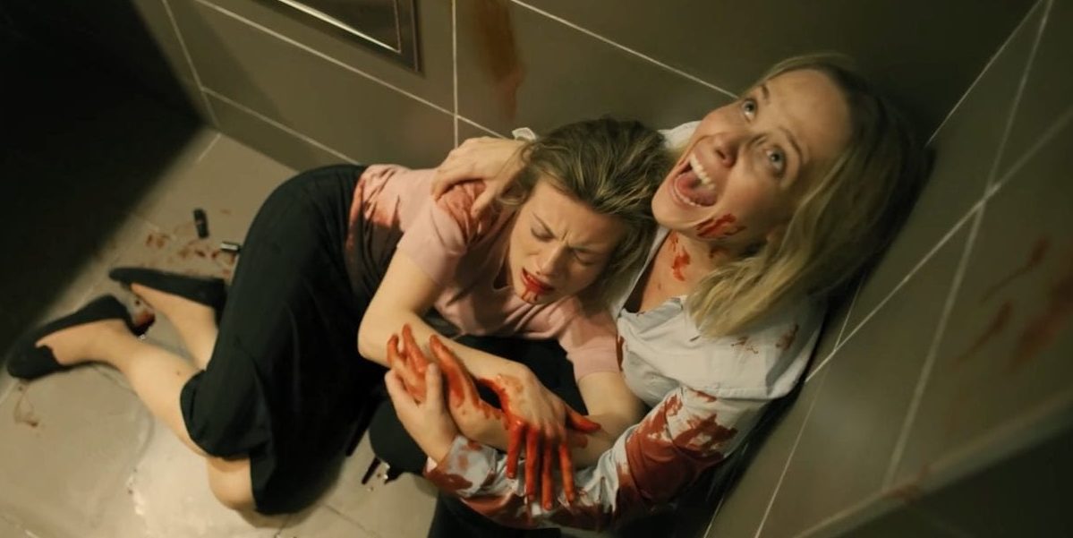 Screaming for help, Marcy holds an injured woman in the corner of a bathroom.