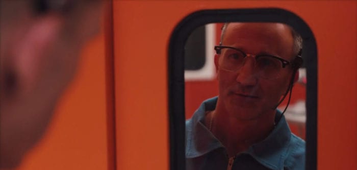 Major Ted Lockwood (Breckin Meyer) looks through the window of a closed door on a spaceship, from the TV show, "Creepshow."