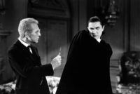 Dracula recoils from a cross presented by doctor Helsing