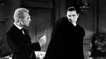 Dracula recoils from a cross presented by doctor Helsing