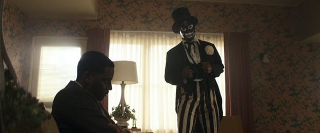 Henry sits on a couch while Da Tap Dance Man leers over him.