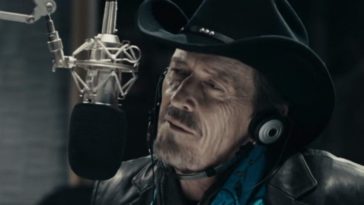 Mazzy sits in front of the microphone in his radio booth