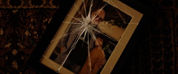 A picture of Dylan and his father in a broken frame